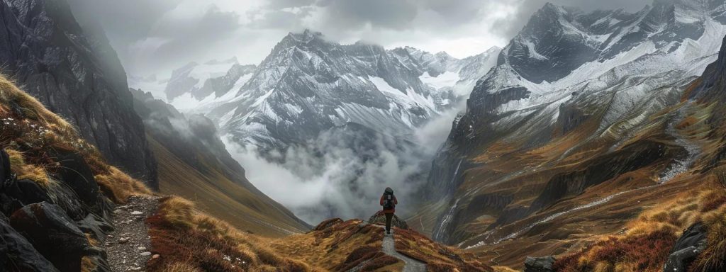 a solitary adventurer navigates a narrow trail through a breathtaking mountain pass, flanked by dramatic, snow-capped peaks and shrouded in a cloud-drenched sky, as soft light breaks through to illuminate the rugged terrain.