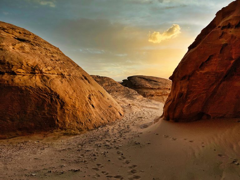 Saudi Arabia desert landscape, rocky path with footprints travel inspiration
